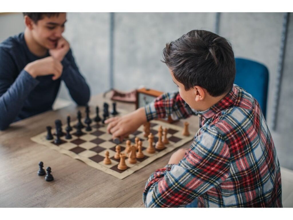 Child learning chess with a coach during an in-person chess lesson