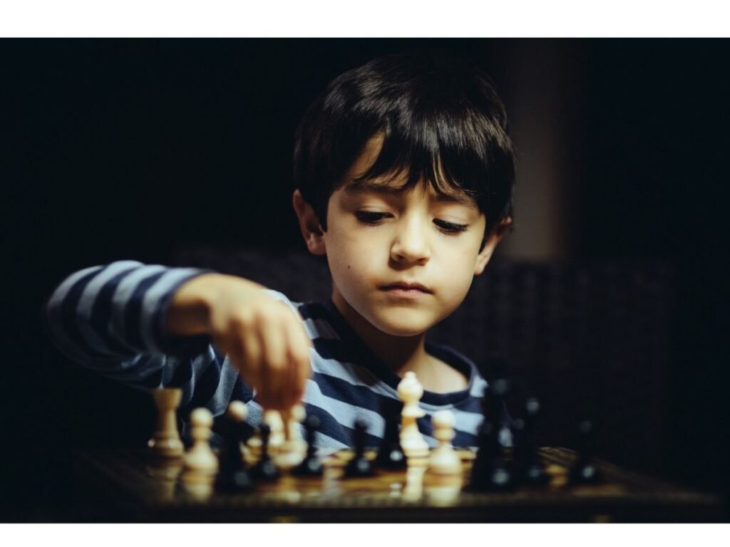 Child concentrating while thinking about a chess move