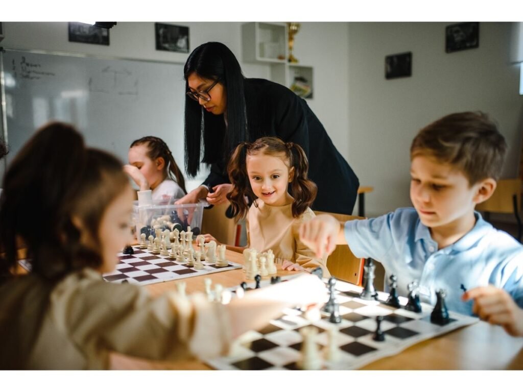 Children learning chess with an instructor in a structured class