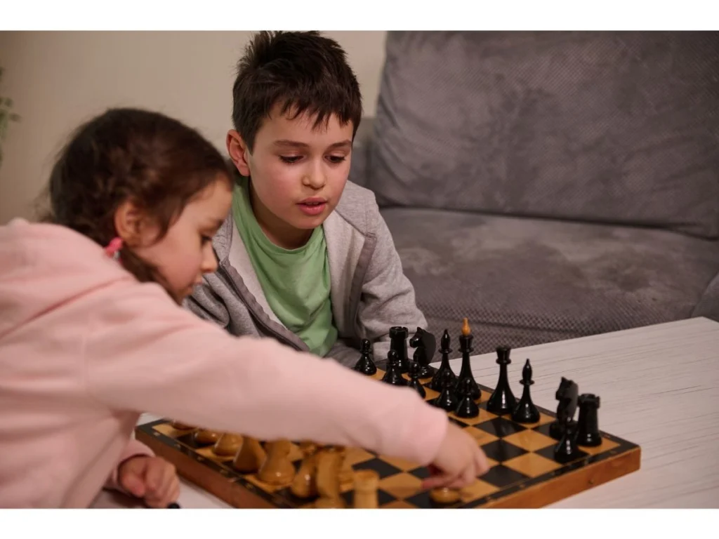 Children playing chess together and learning through practical play