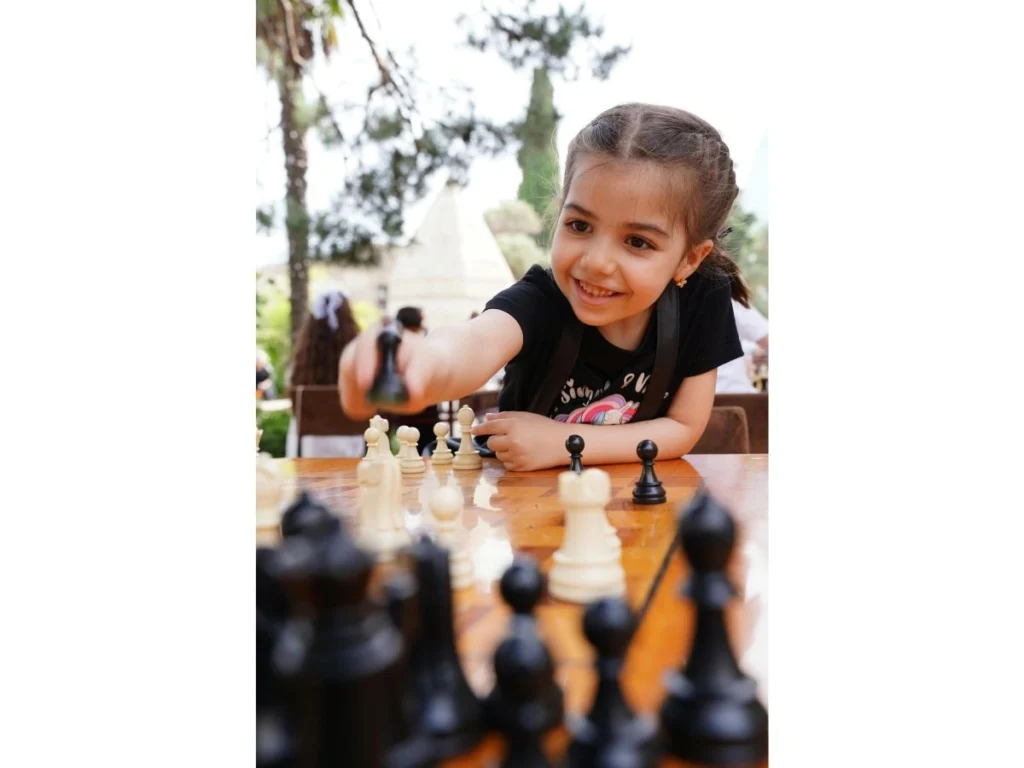 Young girl concentrating while playing chess