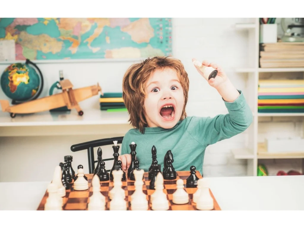 Young child playing chess and exploring the chessboard